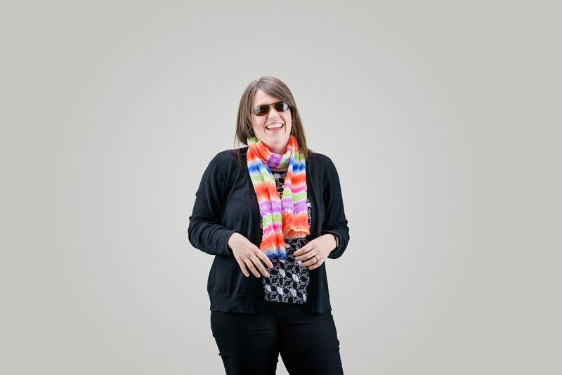 laughing woman with sunglasses and scarf